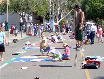 Chalk artist standing on ladder