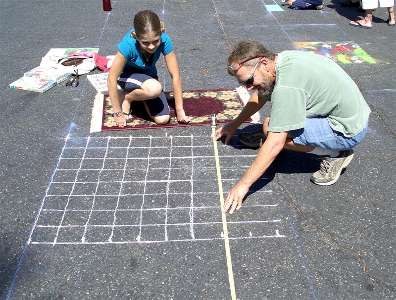 Child artist starting chalk painting grid